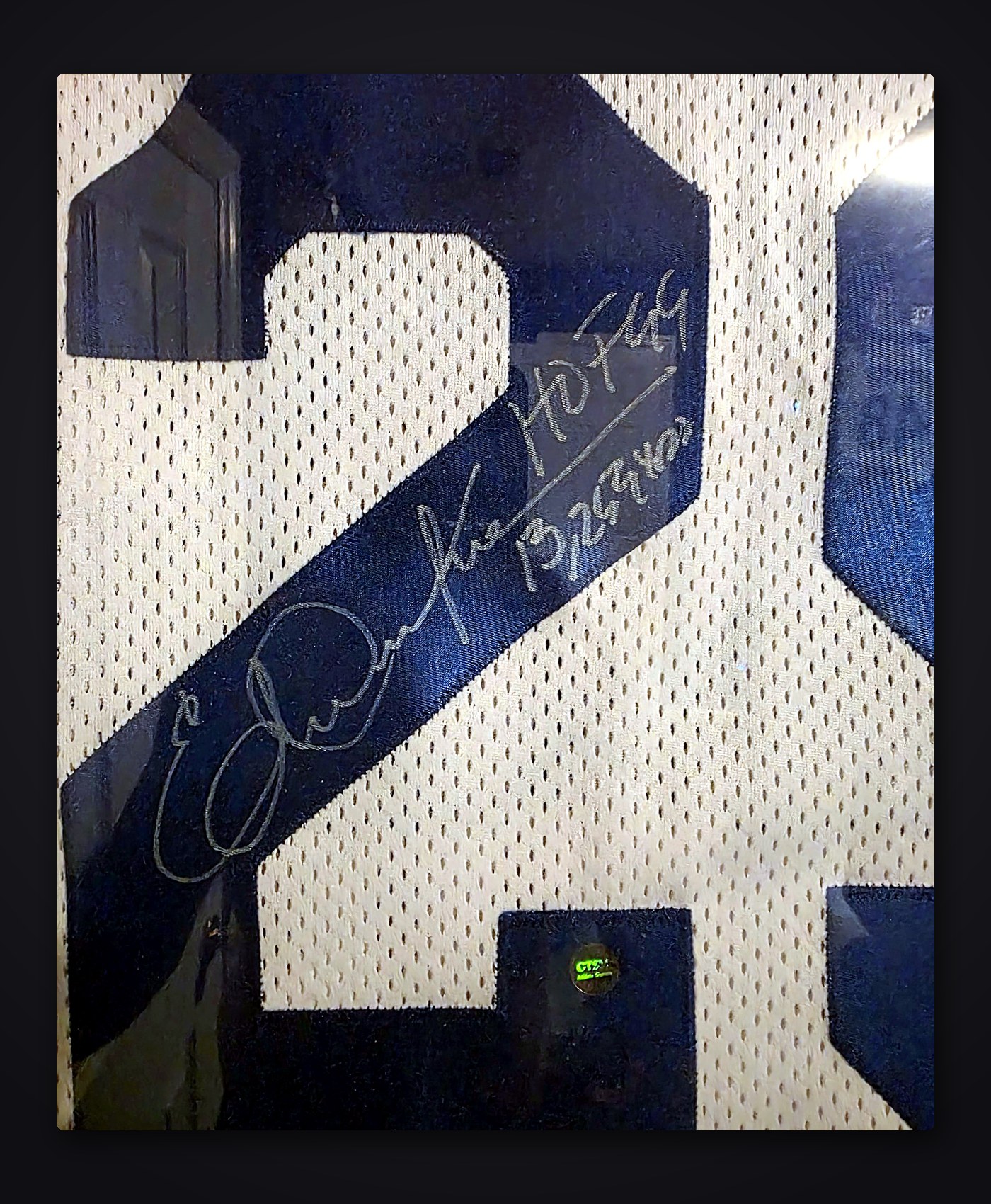 Close-up of Eric Dickerson's silver signature with HOF 99 and 13,259 yds inscriptions