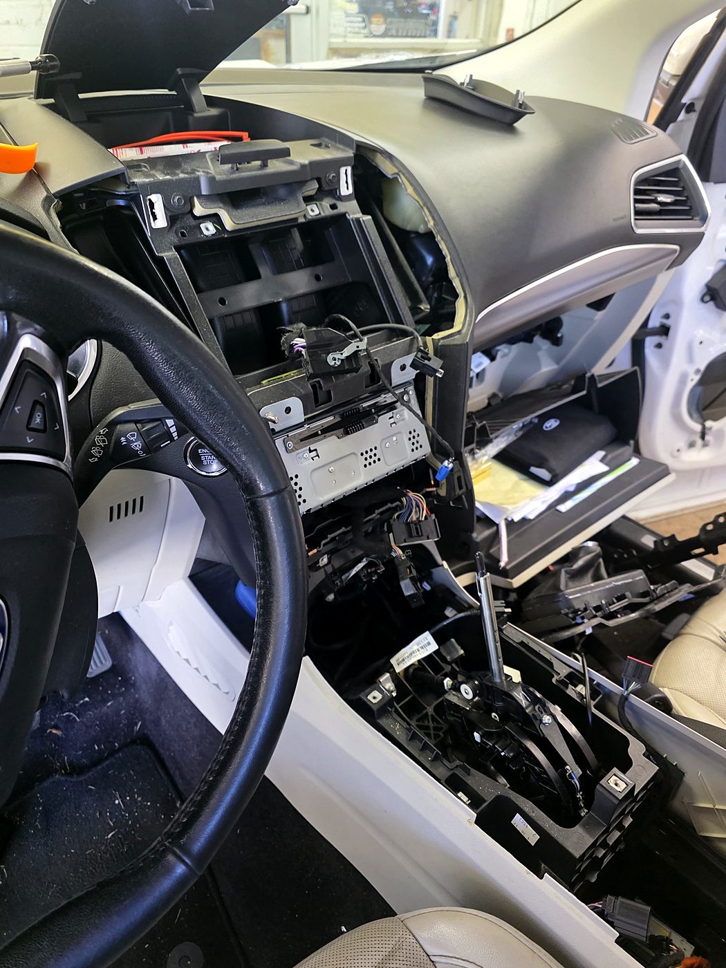 Ford Edge dash and center console taken apart with the factory radio exposed