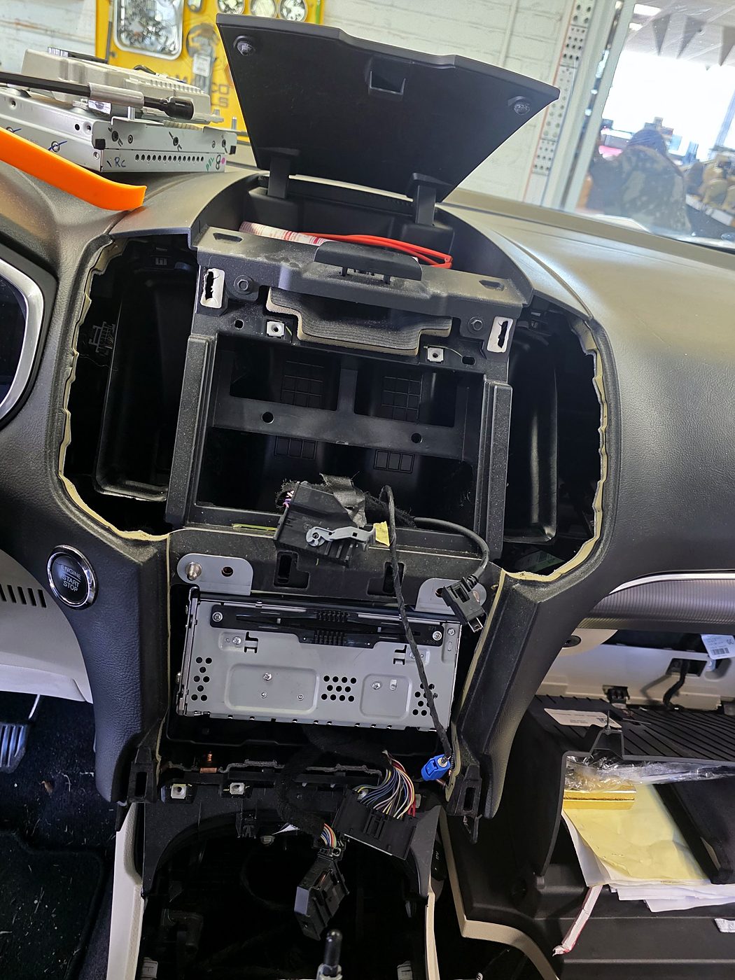 Ford Edge dash with the factory screen removed, showing the radio bracket and wiring