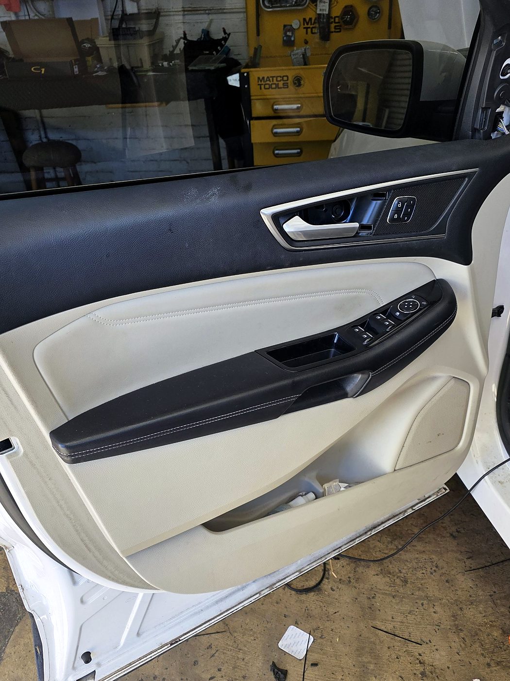 Ford Edge door panel reinstalled after the speaker upgrade