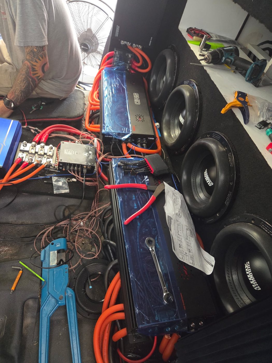 Amplifiers and 0 gauge power wire laid out next to the Sundown subwoofers