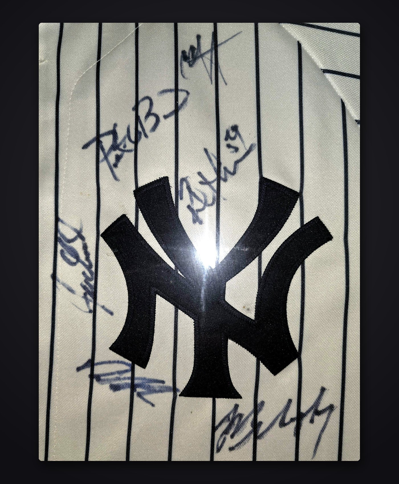 Close-up of the signatures around the interlocking NY logo